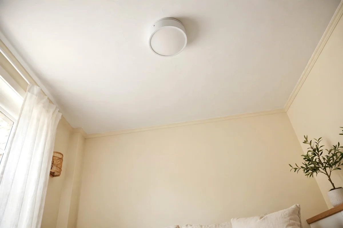 Small living room with a bright white ceiling and simple flush mount light